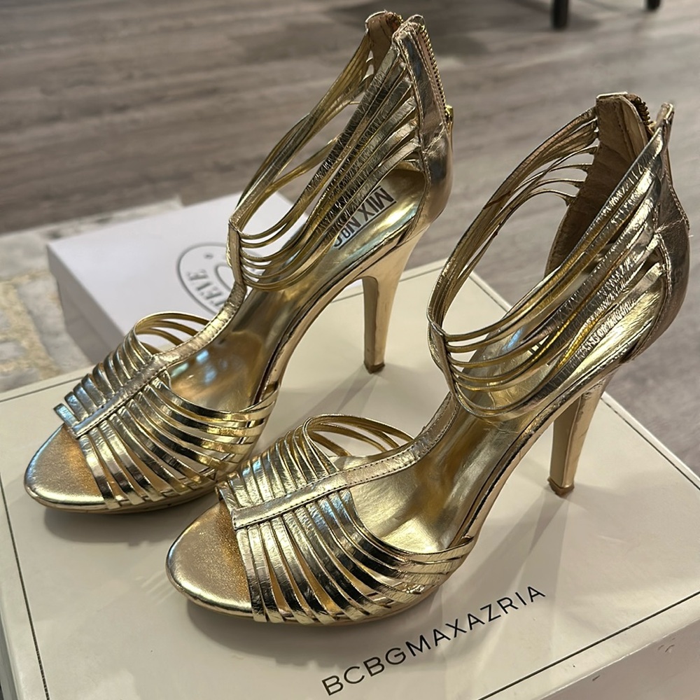 Gold strapped high heels with zippered back.